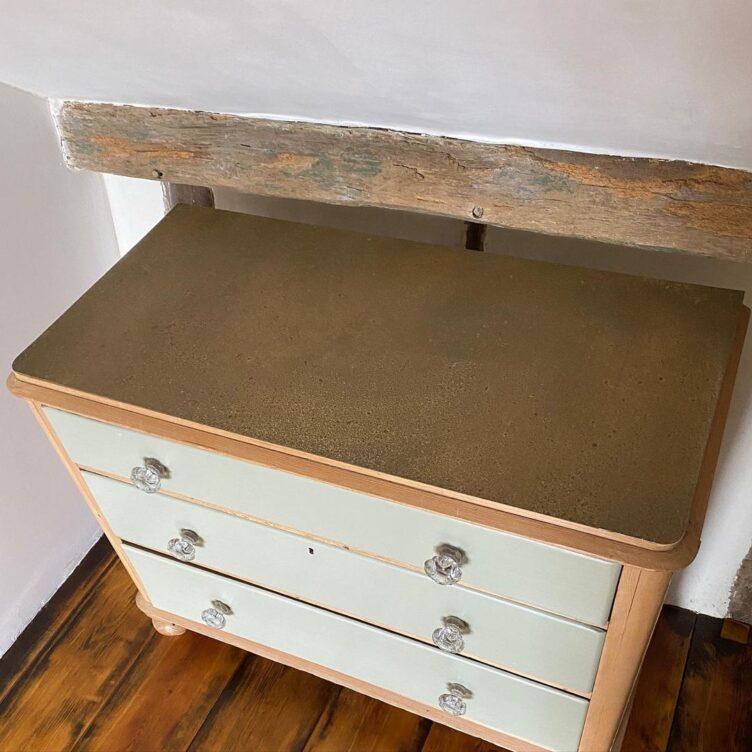 Cupboard finished with aged brass sheet