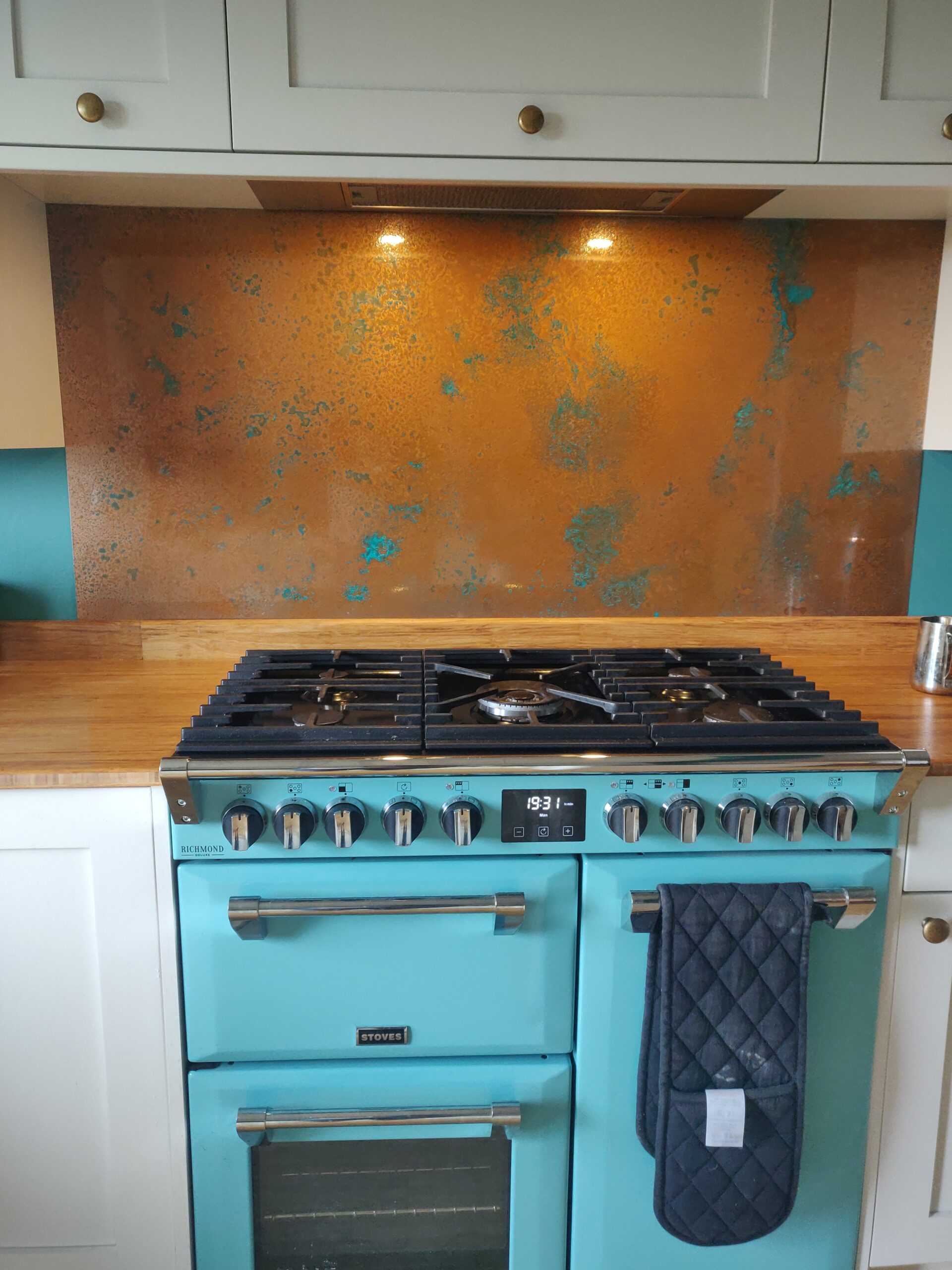 aged copper behind turquoise stove