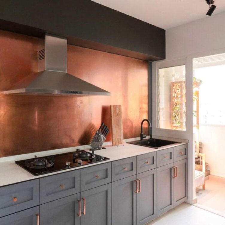 orange copper splashback in modern grey kitchen