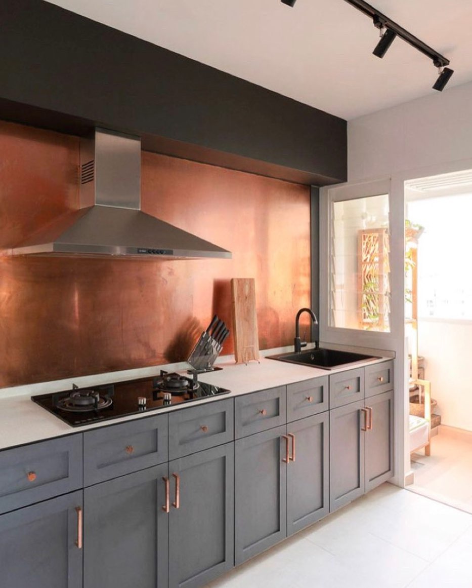 orange copper splashback in modern grey kitchen