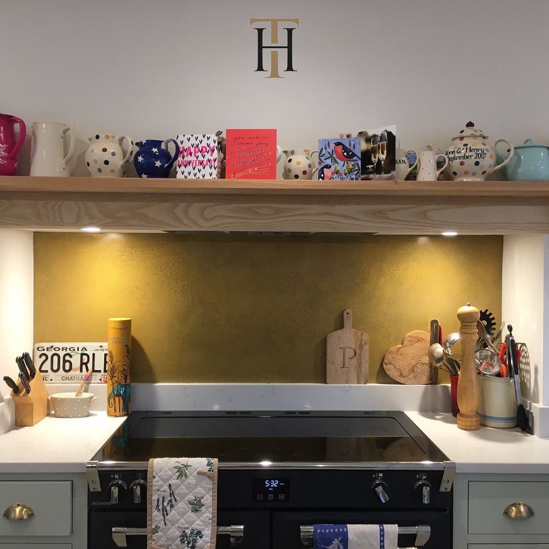 aged brass splashback behind hobs