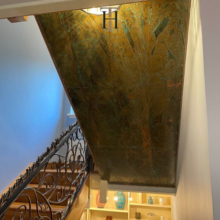 aged copper panels under staircase