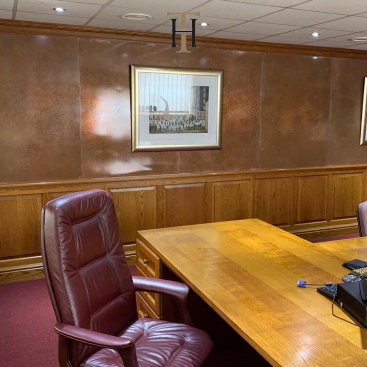 aged copper wall panels as feature wall in boardroom
