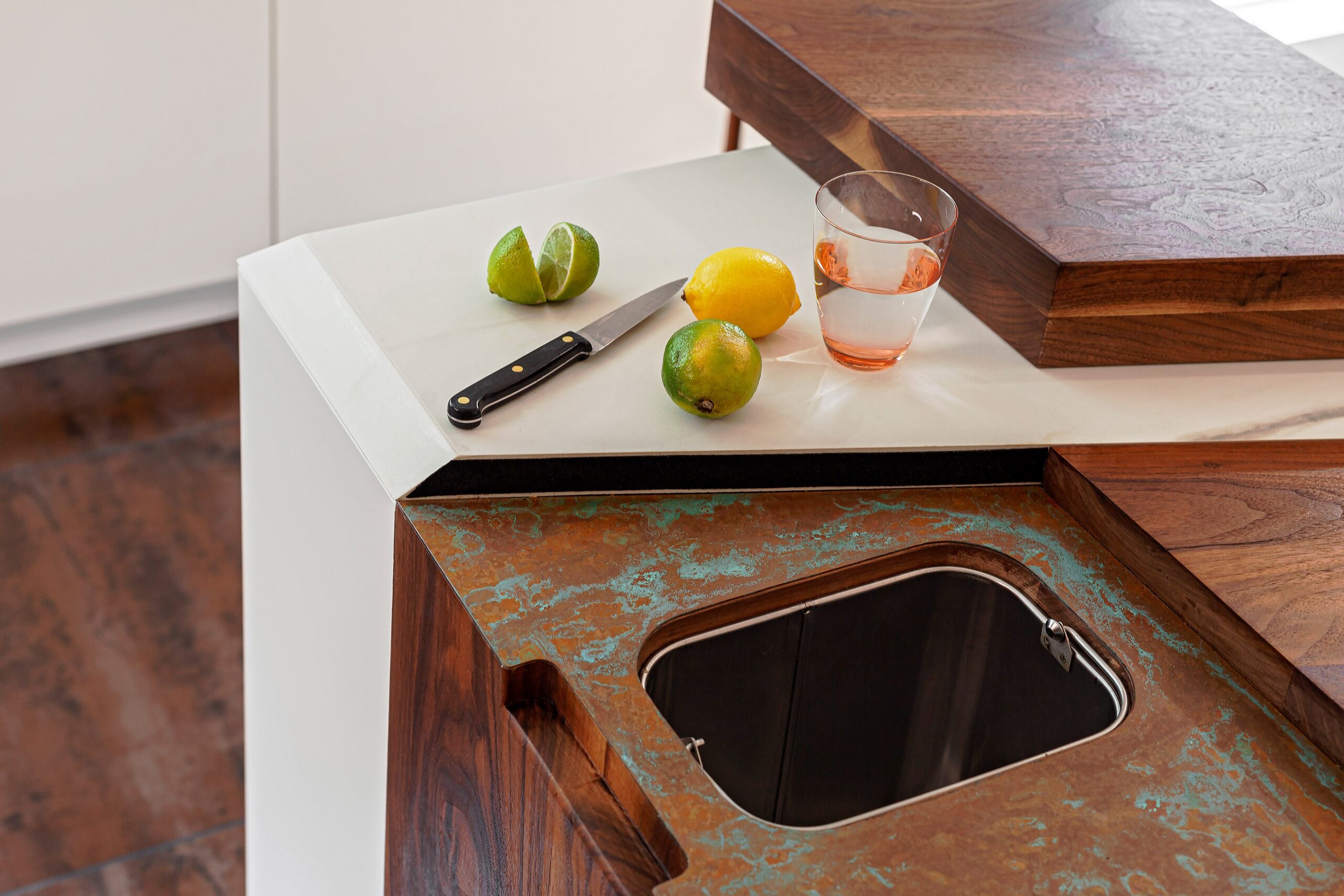 aged copper kitchen worktop with cutout for garbage disposal