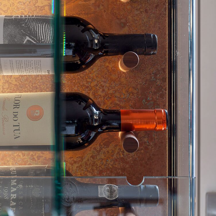 aged copper sheet used decoratively behind wine wall