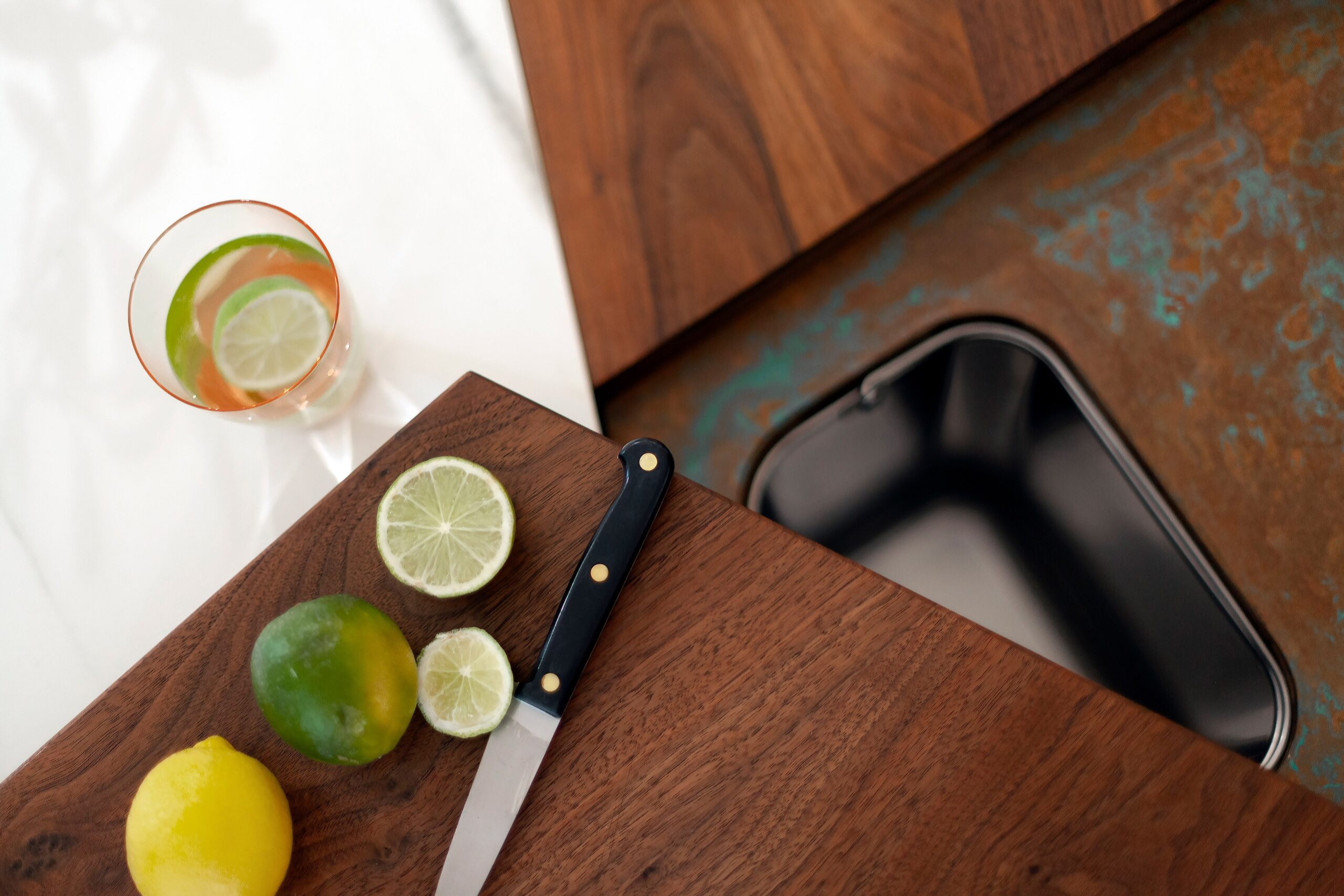 kitchen cutting board above aged copper and wood worktop