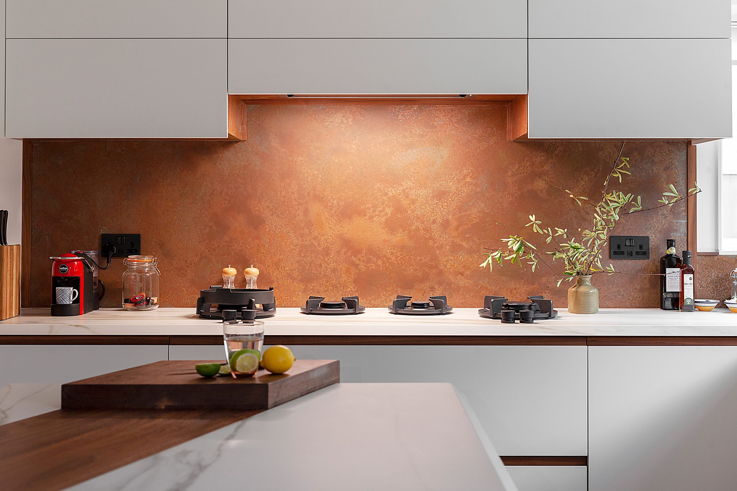 copper splashback with cutouts for plug sockets