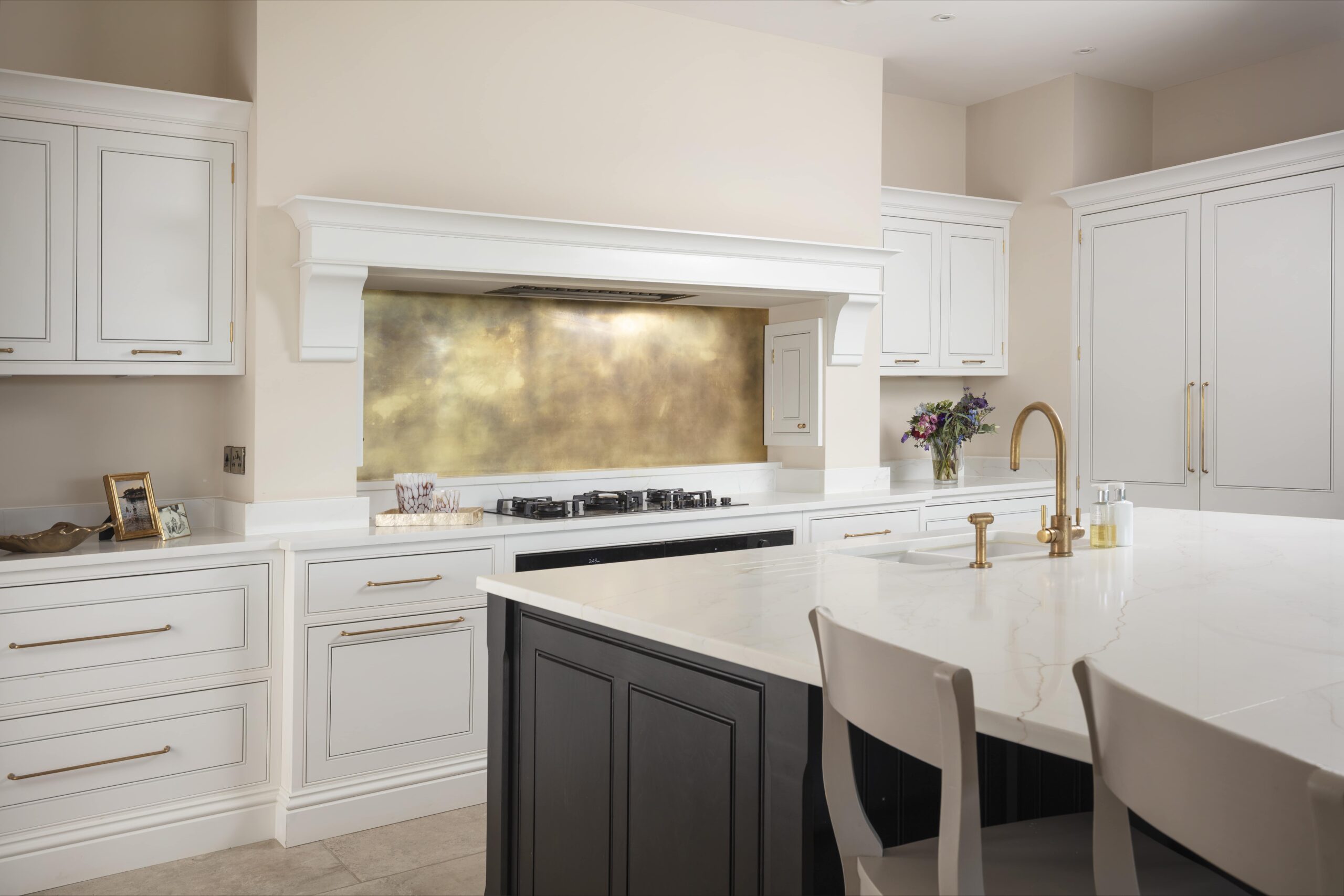 brass patina backsplash in white kitchen