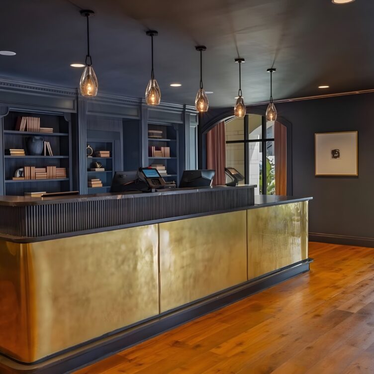 The Publisher Hotel aged brass reception desk